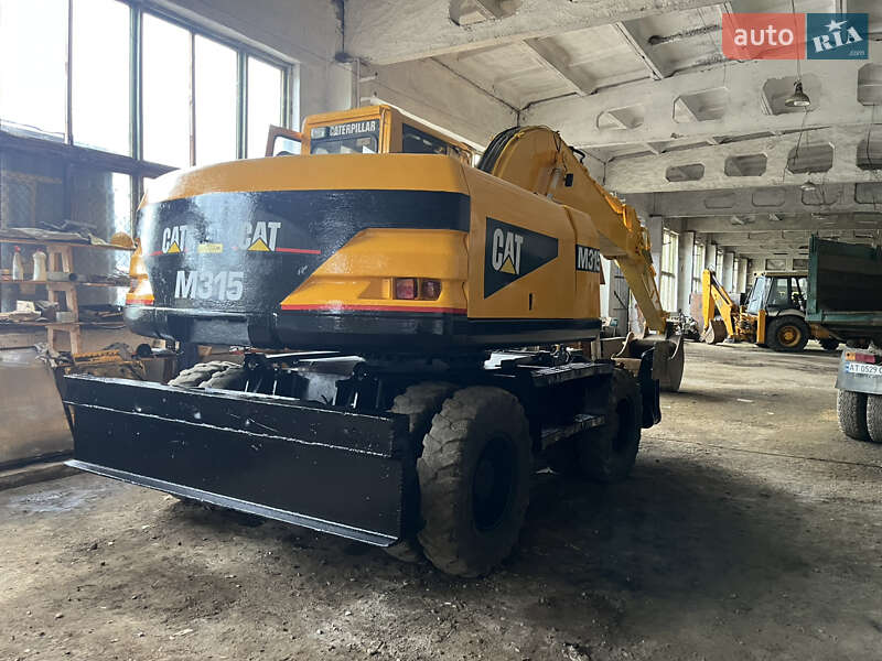 Колесный экскаватор Caterpillar 315 2001 в Косове