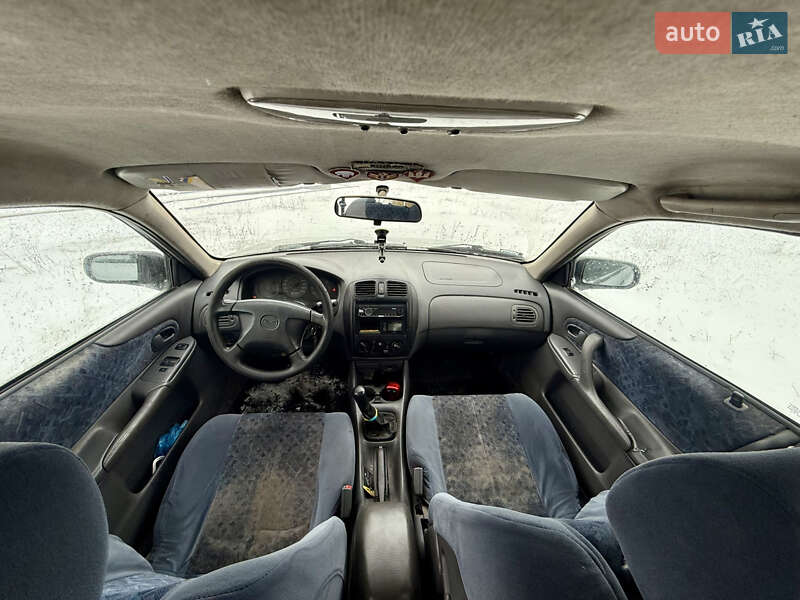 Хэтчбек Mazda 323 1999 в Калиновке фото 14 Хэтчбек Mazda 323 1999 в Калиновке